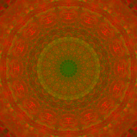 Colorful mandala with fiery red tones and some green in it.