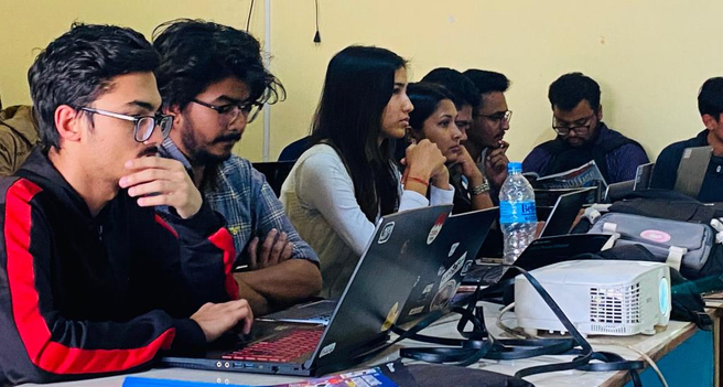 Image of students working on laptops