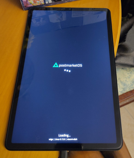 Tablet showing postmarketOS boot screen