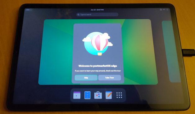 Tablet showing GNOME Shell with "welcome to postmarketOS edge" popup
