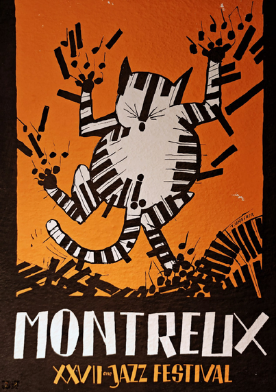 A Montreux Jazz Festival poster with an orange background featuring a stylized cartoon cat playing piano. The cat is white with black stripes, drawn in a whimsical style with musical notes emanating from its paws. The bottom of the poster reads "MONTREUX" in large white letters, with "XXVII JAZZ FESTIVAL" in smaller orange text below. 