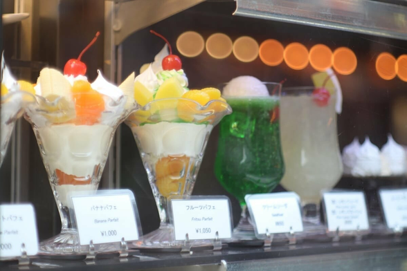 A  plastic display showing a number of parfaits and drinks available in a kissa in Tokyo