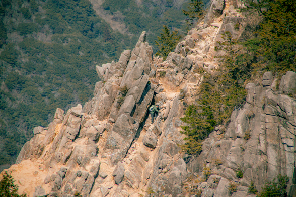 A hiker climbing up a mountain.