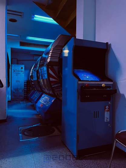 A Pac-Man cabinet in the back of the arcade.