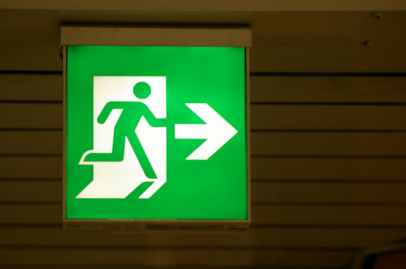 Green exit sign showing a male figure running