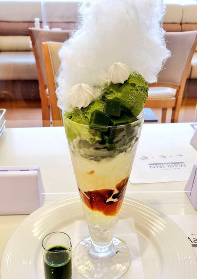 Matcha and coffee parfait topped with cotton candy.