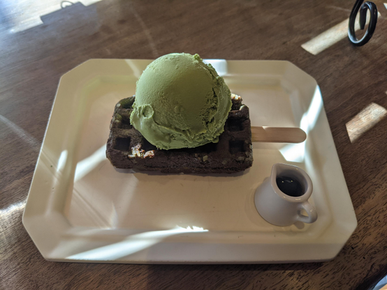 Matcha ice cream on a chocolate waffle.