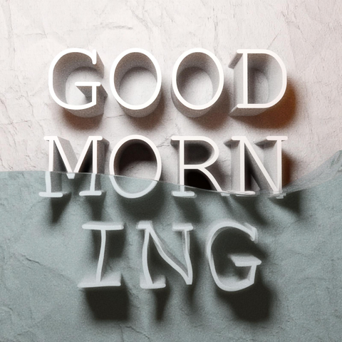 white marble background with water in front and 3D letters reading Good morning