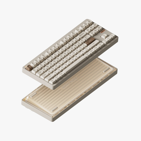 NuPhy Gem80 mechanical keyboard in Cosmic Mocha colorway. The image shows a split view with the fully assembled 75% layout keyboard on top featuring beige keycaps and a brown accent key, and below it the transparent bottom case that reveals the internal structure. The base has “NUPHY STUDIO” (all caps) branding engraved on it.