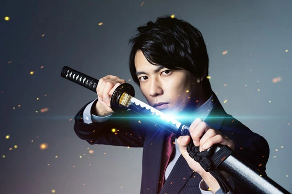 Businessman in suit unsheathing samurai sword