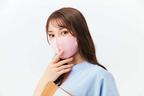 Woman wearing a pink mask