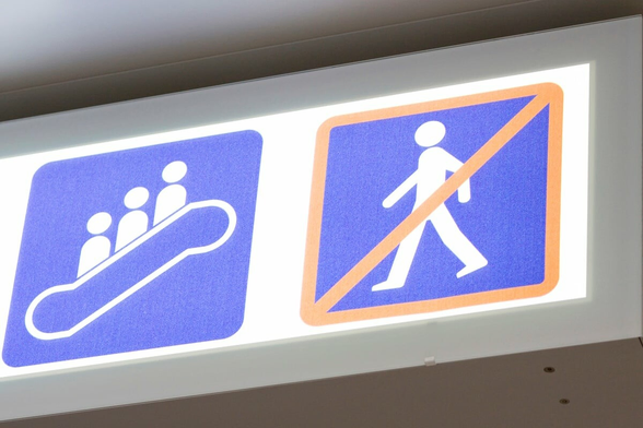 Sign showing standing on the escalator and prohibiting walking