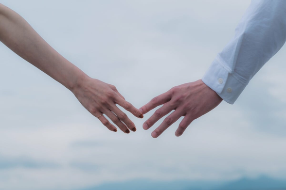 Picture of a man and a woman about to hold hands