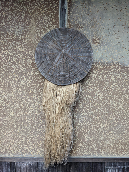 A mino straw raincoat, hung at the entrance of Rakushisha (here it denotes the host is home).