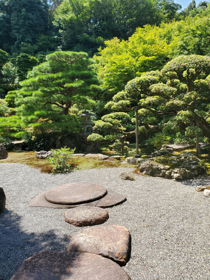 Giant stepping stones lead out into the garden at Kyutei Omuro.