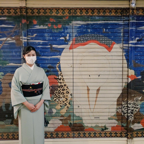Nao-san poses outside one of Nishiki Market's decorated shutters. Ito Jakuchu, one of Japan's most famous painters, was born at the west end of Nishiki.