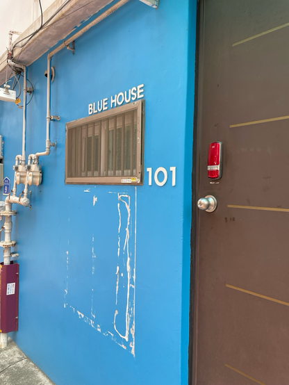 An old blue building labeled Blue House 