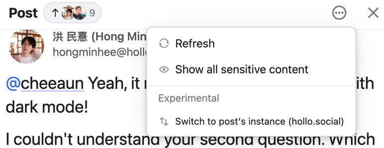 A social media post interface showing a user comment. A menu is open with options to Refresh, Show all sensitive content, and an experimental option to switch to the post's instance (hollo.social). The post includes a mention to another user and a comment about dark mode.