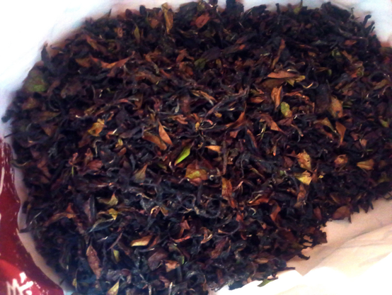 The photo of well-dried tea leaves in a paper bag.