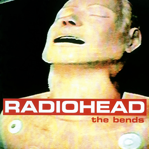 Album cover with big white type on red that says RADIOHEAD in all caps over a CPR mannequin’s portrait with a facial expression like that of an android discovering for the first time the sensations of ecstasy and agony, simultaneously.