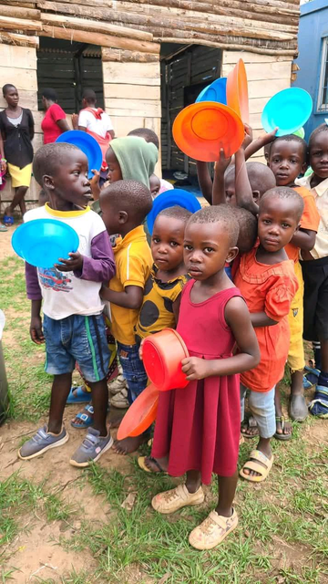 Young children waiting to get food from young farmers 