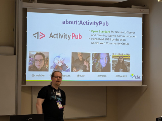 person in front of projected slides with pictures from the accounts mentioned on slide about activity pub.