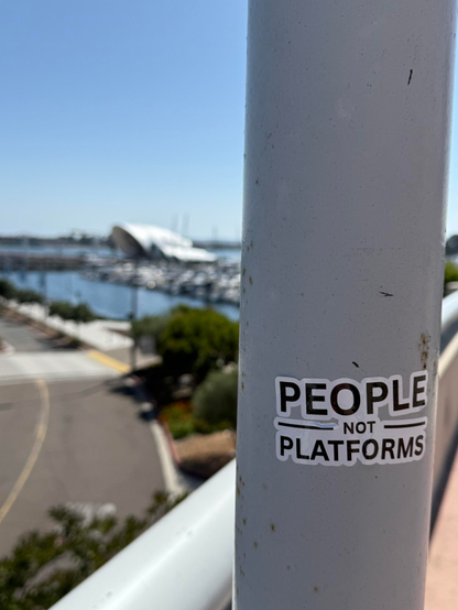 A sticker for the fediverse placed in a lamp post overlooking an amphitheater on the bay in San Diego.