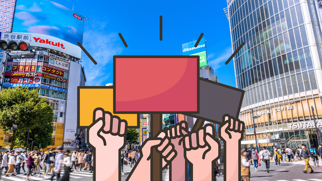 People holding up protest fists and signs in SHibuya 