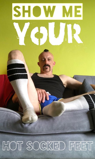 “Show me your hot socked feet” in text over an image of me in blue shorts, white tube socks with black stripes, on a grey couch with green walls.