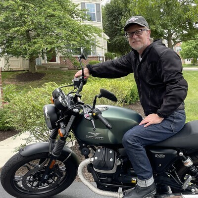 Kevin Tofel sitting on a 2015 Moto Guzzi V7 Stone motorcycle.