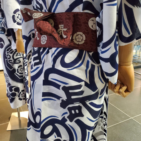 Stylised kanji on the yukata of the Naginata-boko float.