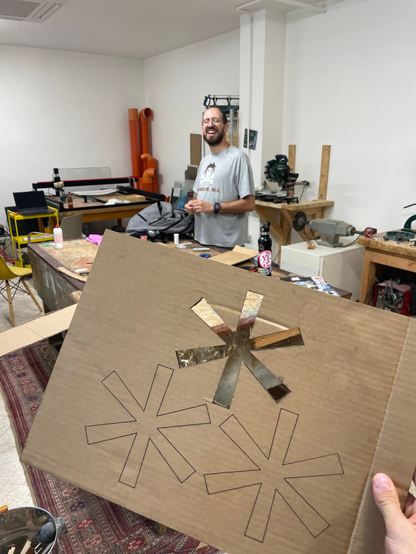 The Fediverse symbol engraved in a cardboard stencil, and Maurizio smiling on the back.