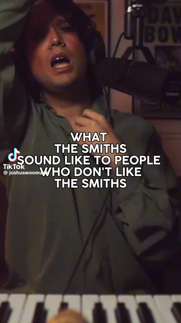 A young man is sitting in front of a microphone and singing a not bad impersonation of Morrissey.