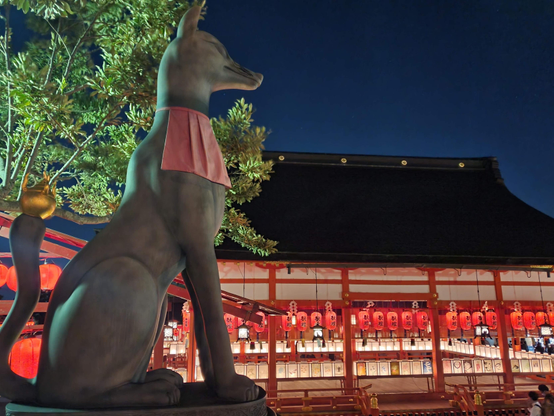 A kitsune statue looks down upon the Motomiya-sai celebrations.