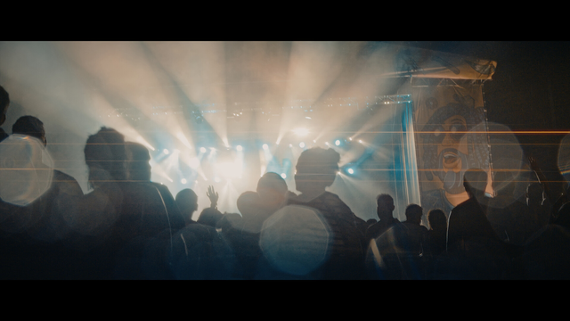 A shot from a music stage with silhouetted people in front.