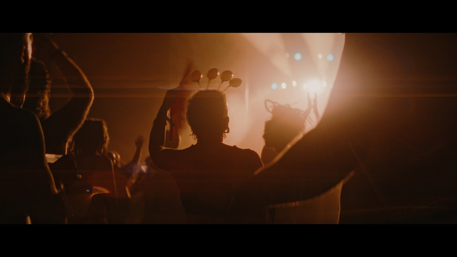 A shot from a music stage with silhouetted people in front.