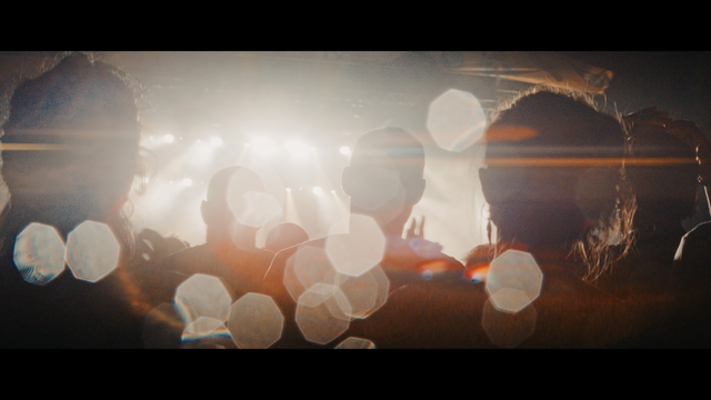 A shot from a music stage with silhouetted people in front.