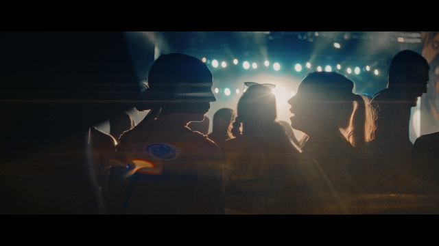 A shot from a music stage with silhouetted people in front.