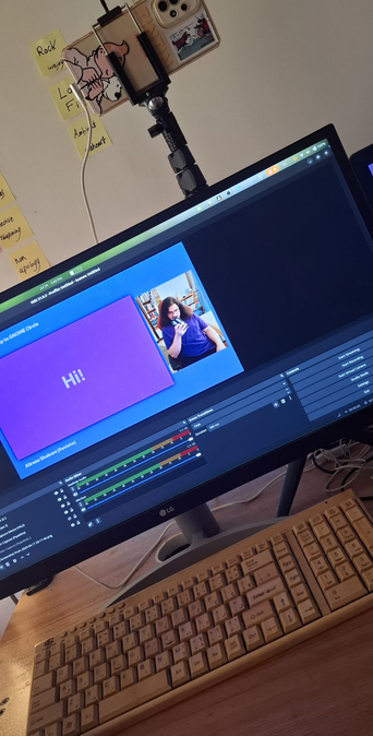 A picture of my setup, showing my monitor and OBS application, my keyboard and the phone which is used as a camera