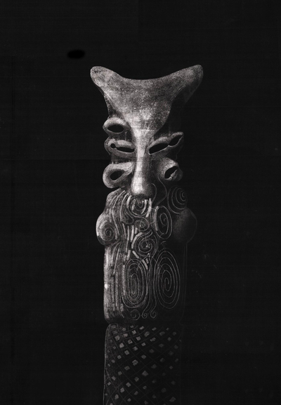 A black and white drawing of an ancient statue reminiscent of a strange creature with multiple mouths/eyes on a black background. Inspired by Sumerian demon statues.