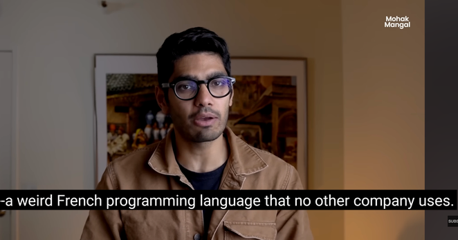 Screenshot of a YouTube video that claims that Jane Street uses "a weird French programming language that no other company uses" so that no other companies will hire their employees.