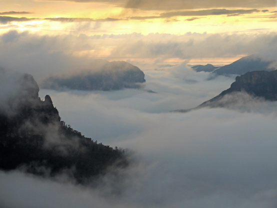 Mist rises around the rocky outcrops in the Grose Valley, part of the Blue Mountains World Heritage Area in Australia