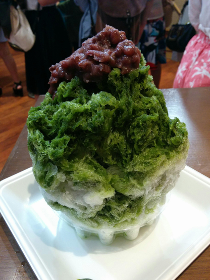 Matcha flavoured kakigori topped with sweet red bean paste.