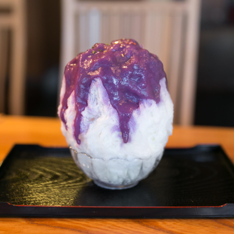 Kakigori topped with a purple syrup of sweet potato.
