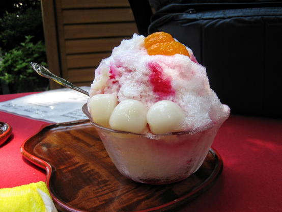 Strawberry kakigori with mikan slics and mochi balls.