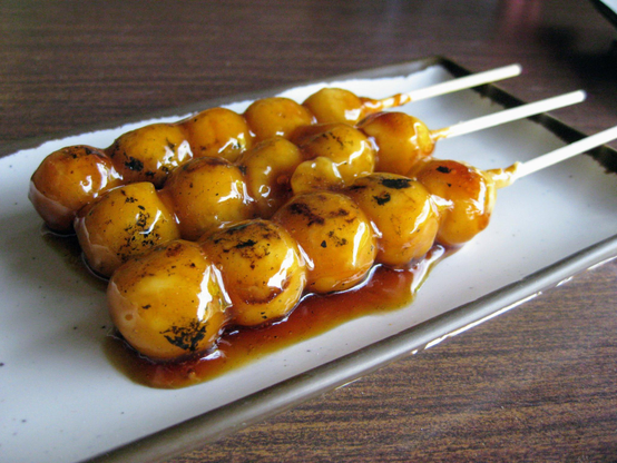 Mitarashi dango are skewered balls of rice dough covered in a sweet and slightly salty sauce (there are typically between 3 and 5 balls per skewer).