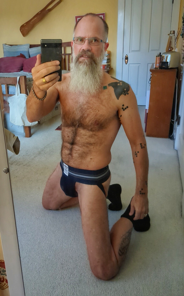 Semi-nude male in a jock on his knees