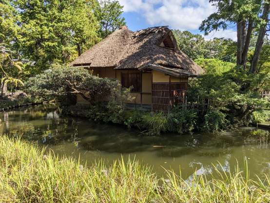 Thatched hut on an island in the pond at Umenomiya Taisha.