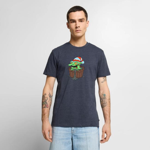 Stock photo of tattoed man wearing a t-shirt featuring a cartoon goblin sitting in a bucket of slop.