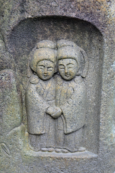A dosojin (道祖神) statue, here depicted as a couple. These Japanese folk deities protect travelers, pilgrims, villages, and boundaries. When seen as a couple they also represent fertility.